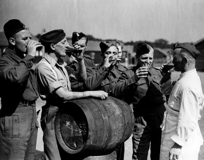 British troops released from a German prison camp in 1944 drinking English beer for the first time in four years.