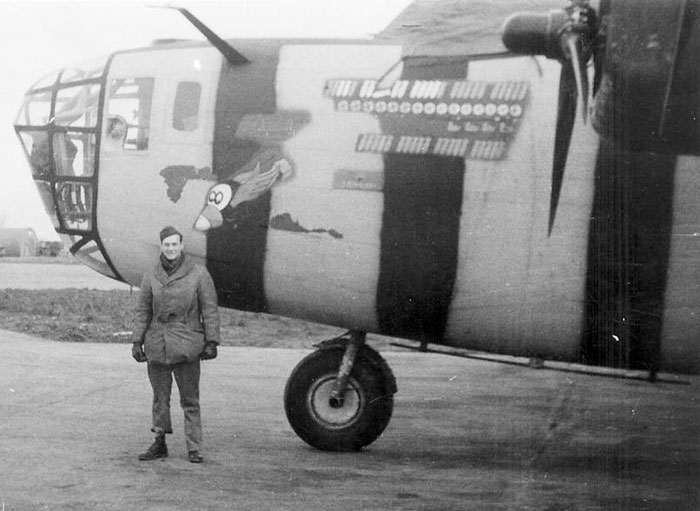 An airman poses with Consolidated B-24D Liberator Lemon Drop (USAAC Serial No. 41-23699), an assembly ship of 44th Bombardment Group, 68th Squadron at RAF Shipdam, Norfolk, England