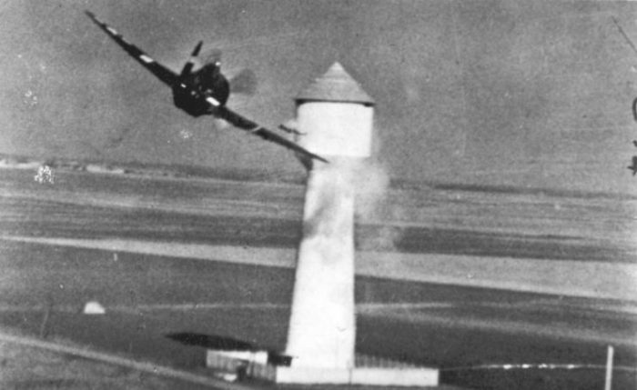 An 8th U.S. Air Force Republic P-47D Thunderbolt attacks a tower on a German airdrome in occupied France, in 1944.