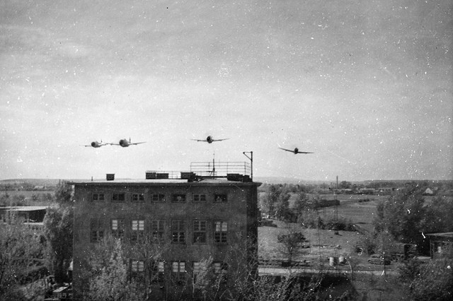 1945 World War II photo of American Republic P-47 Thunderbolts buzzing American troops in Brunswick, Germany