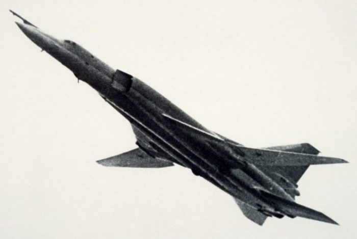 A left side view of a Soviet Tu-22M Backfire aircraft climbing after takeoff.