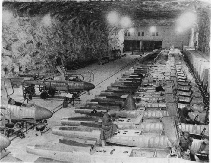 An underground production line of He 162 aircraft. When viewing these conditions, its easy to understand why the workmanship declined so dramatically in the later years of the war. Image by Bundesarchiv CC BY-SA 3.0 de.