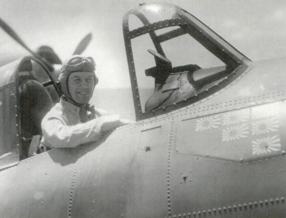 Jimmy Flatley sits in his F4F-4 Wildcat—decorated with his victories at Coral Sea, Santa Cruz, Guadalcanal, and Rennell Island—aboard the USS Enterprise’s deck. 1943