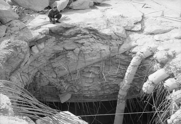 An RAF officer inspects the hole left by a 22,000-lb deep-penetration ‘Grand Slam’ bomb which pierced the reinforced concrete roof of the German submarine pens at Farge, north of Bremen