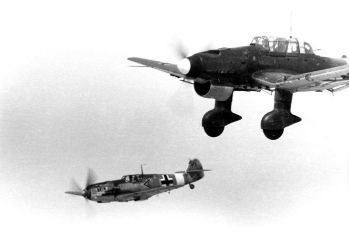 A Messerschmitt Bf 109 and a Ju 87 fly over the Mediterranean. Credit: Billhardt CC BY-SA 3.0