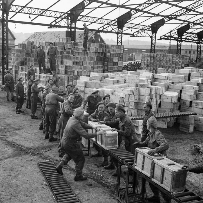 Troops from the Royal Army Service Corp handle ration boxes in the harbour at Dieppe in October 1944.