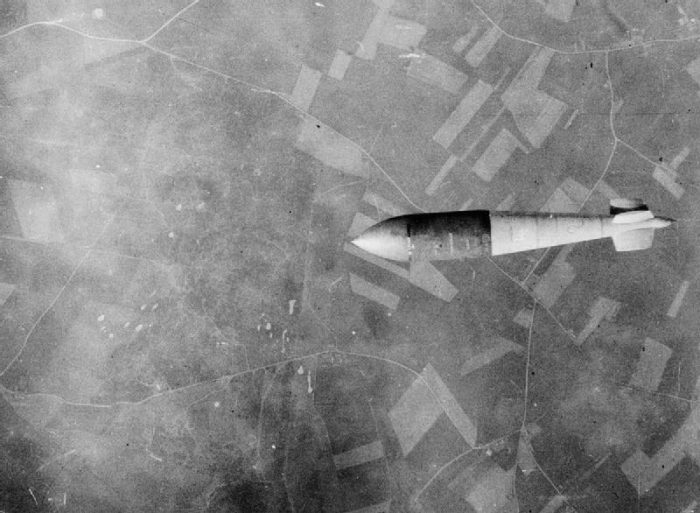A 6.4 metre Tall Boy as its released from a Lancaster bomber over a V-2 rocket launch site.