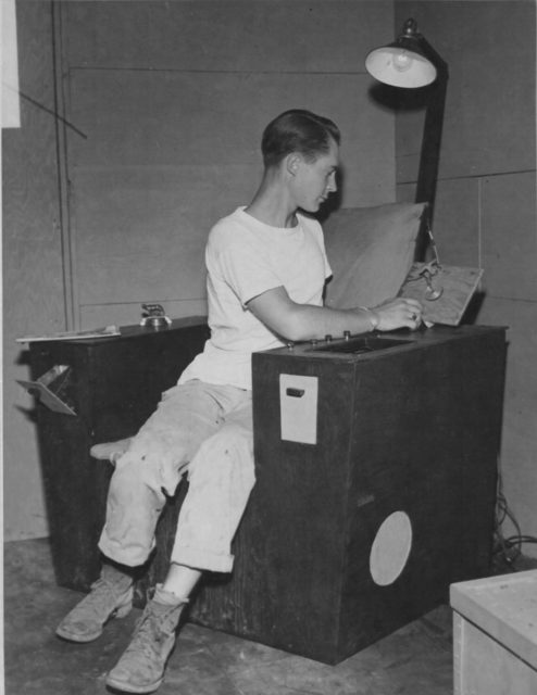 Sergeant Ray Petit of the 15th Air Force in Italy built a chair using the wood crate from a belly tank. His chair is equipped with a reading light, ashtray, magazine rack, and a radio that turns off on a timer once he dozes off. (NARA)