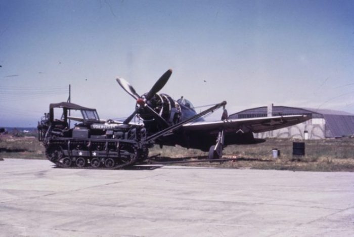 Cletrac in front of a P-47 Thunderbolt of the 406th Fighter Group.
