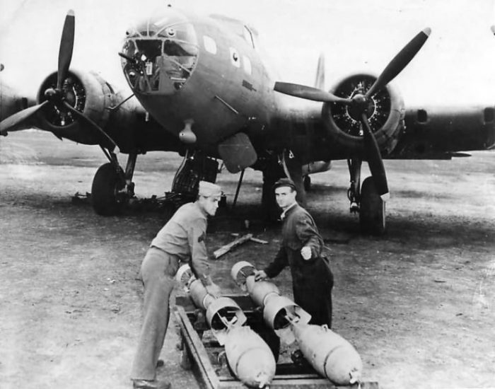 Ground crew loading bombs on B-17E in Australia