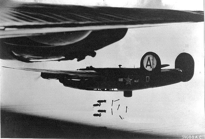A B-24 dropping its bomb load. Note the lack of bomb bay doors externally on the aircraft, and the deployed belly turret.