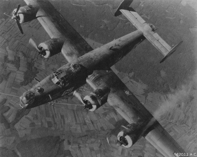 A damaged B-24 Liberator “Burma Bound”, of the 451st Bomber Group returns to base after a raid on Munich.