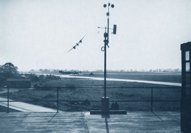 A P-38 Lightning buzzing the field at Lavenham, England which was the home base of the 487th Bomb Group.