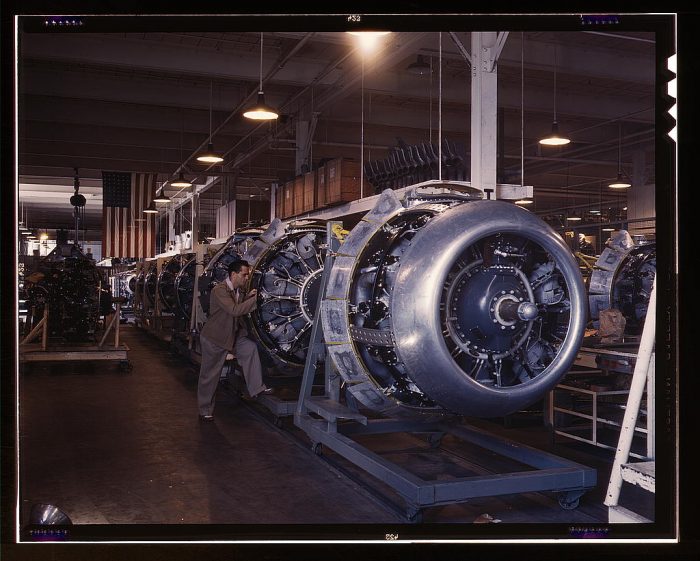 Cowling and control rods are added to motors for North American B-25 bombers as they move down the assembly line, North American Aviation, Inc., Inglewood, Calif.