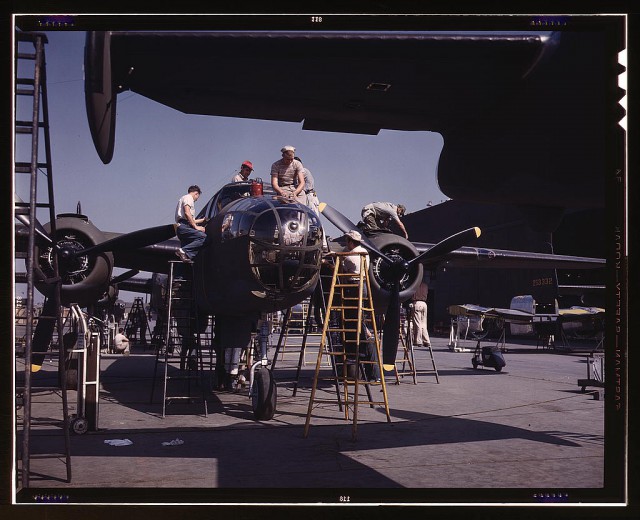 Employees on the “Sunshine” assembly line at North American’s plant put the finishing touches on another B-25 bomber, Inglewood, California. In addition to the battle-tested B-25 (“Billy Mitchell”) bomber, used in General Doolittle’s raid on Tokyo, this plant produces the P-51 (“Mustang”) fighter plane which was first brought into prominence during the British raid on Dieppe