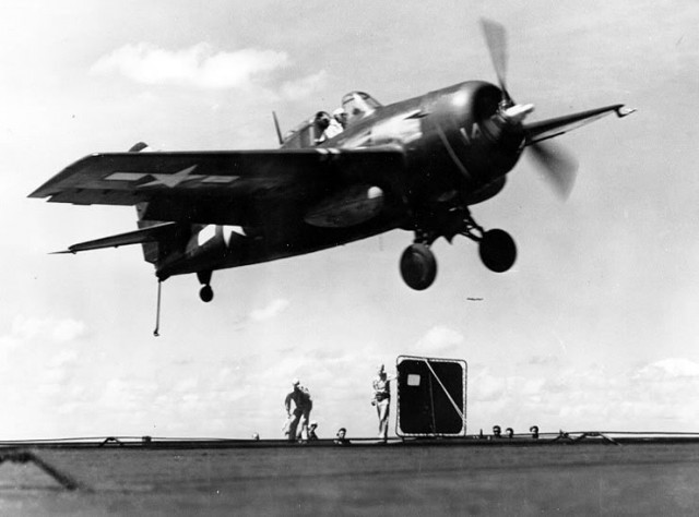 A U.S. Navy Grumman FM-2 Wildcat fighter gets a “wave-off” from the Landing Signal Officer while attempting to land on the escort carrier USS Makin Island (CVE-93), about 1944/45.