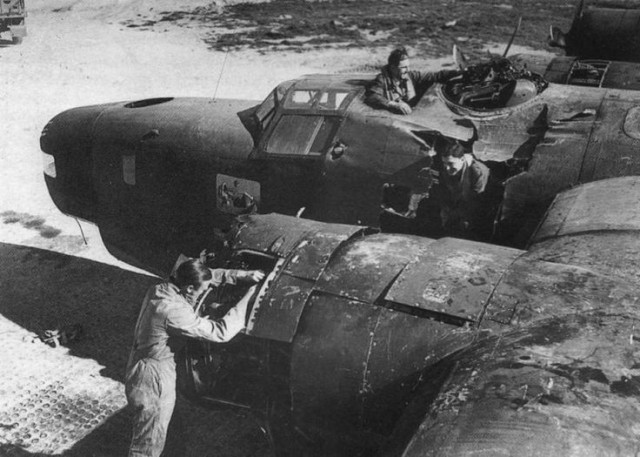 Inspection of a damaged B-24 after being hit by the 1000-pound bombs. March 14, 1945