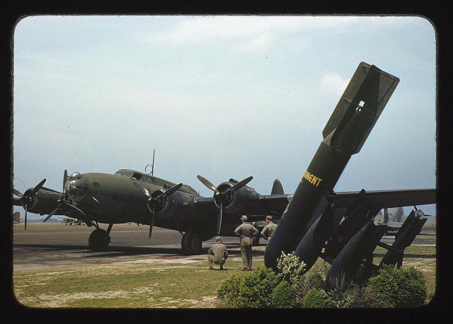 One of America’s new warships of the air, a mighty YB-17 bomber, is pulled up at a bombardment squadron hangar, Langley Field, Va. It is set to taxi out to a runway and take off on a mission.