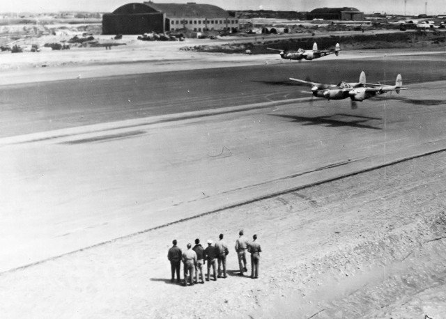 P-38 Lightnings making a low-level pass over the runway at Shemya AAF, 1 August 1945 during the Armed Forces Day celebration
