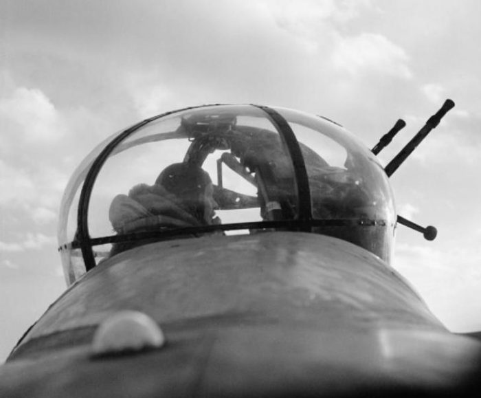 A No 57 Squadron mid-upper gunner, Sergeant ‘Dusty’ Miller, ‘scans the sky for enemy aircraft’ from a Lancaster’s Fraser Nash FN50 turret.