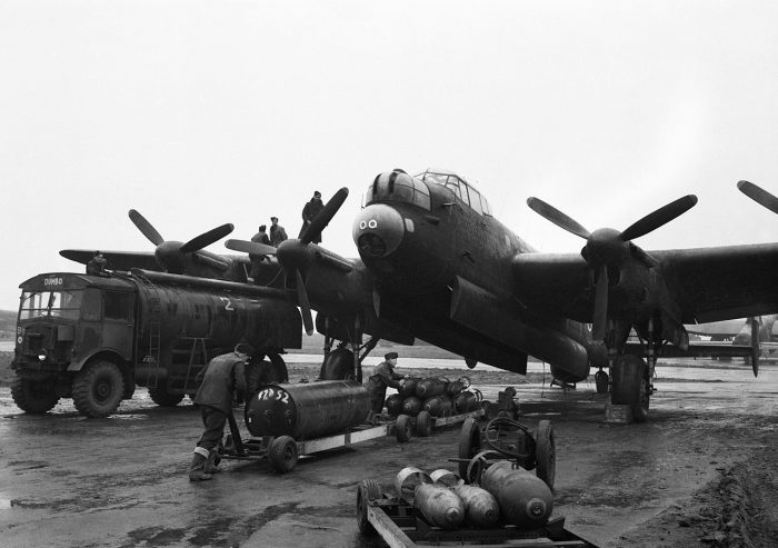 Ground crews refuelling and bombing up an Avro Lancaster at Mepal, Cambridgeshire, for a night raid on Krefeld, Germany.