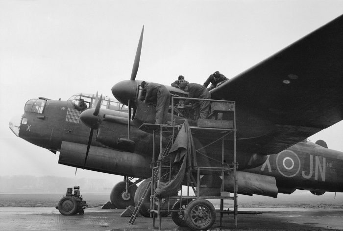 Mechanics working on the port-outer Merlin engine of a Lancaster at Mepal, Cambridgeshire, 9 February 1945.